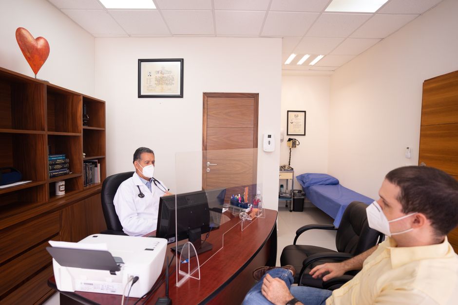 Cardiologist discussing cardiac health screening results with an international patient in Korea