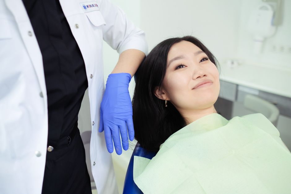 Patient receiving dental consultation at a modern Seoul dental clinic before implant surgery