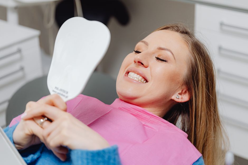 Patient smiling with noticeably whitened teeth after professional dental whitening treatment in Korea
